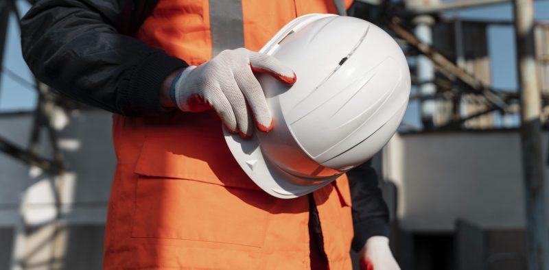 close-up-hand-holding-safety-helmet